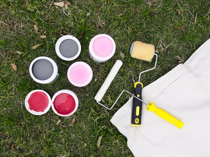 All you need to create your own is a canvas drop sheet (they come in all manner of shapes and sizes), a variety of different paint colours (we went with grey, pink, and red) and different-sized rollers to make the stripes. I know, I know, I’m definitely breaking some design rules with the red and pink combo but I just think they go so well together! Am I crazy?!