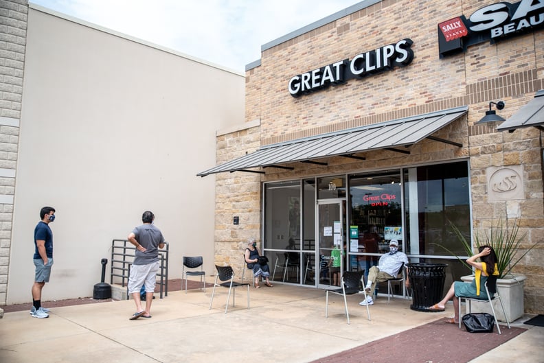 People wait for their haircuts outside Great Clips amid the coronavirus pandemic in Round Rock, Texas on May 8, 2020 following a slow reopening of the Texas economy. - A Texas hairdresser was sentenced to seven days in jail for keeping her salon open in v