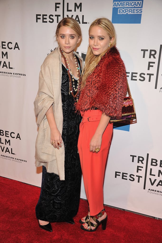 Twinning combo: Proving their expertise in mixing eclectic prints with textures, Mary-Kate and Ashley turned heads at the 2011 Tribeca Film Festival.

Ashley shrugged a burlap-hued shawl over her black-and-silver brocade maxi, then tossed on an array of boho-chic necklaces and rings.
Mary-Kate's love of fur extended with a cropped orange-and-red creation, coordinating trousers, and python sandals.