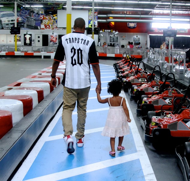 She held onto his hand before racing go-karts.