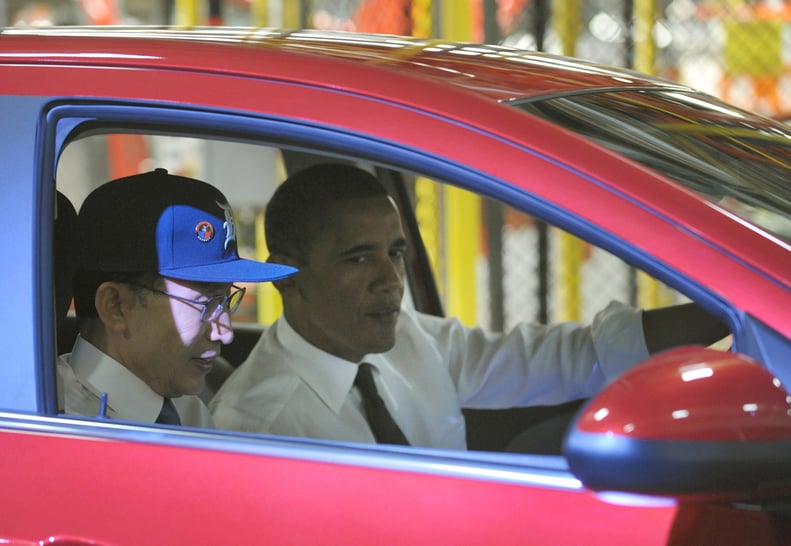 Riding with South Korean President Lee Myung-Bak at a General Motors factory in 2011.