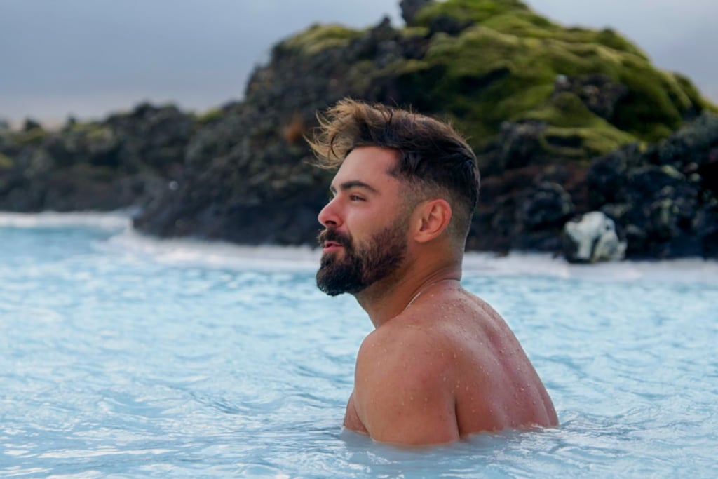 Efron, in his natural element, takes in the views of Iceland as his hair blows in the wind.