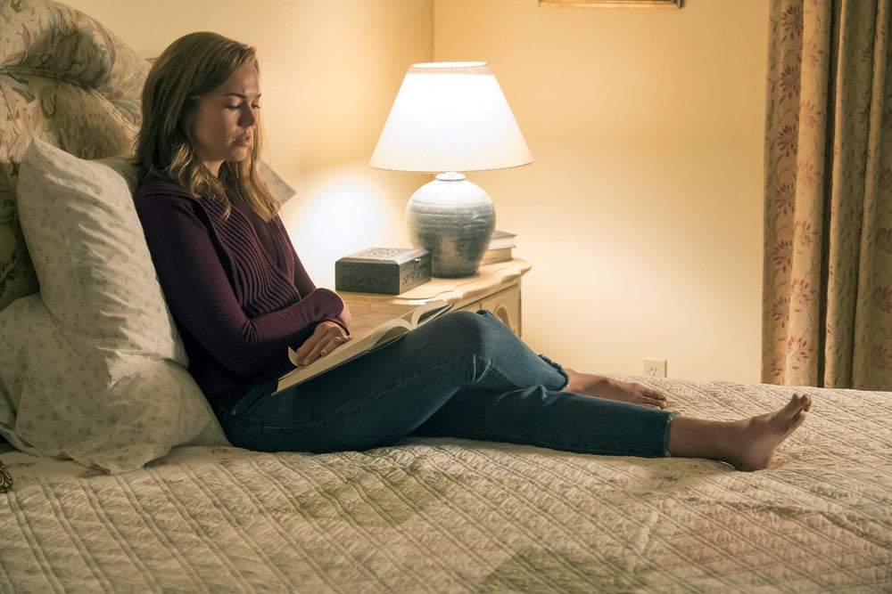 Even though she's relaxing in bed with a book, Rebecca is looking deeply troubled. Maybe she's reading It?