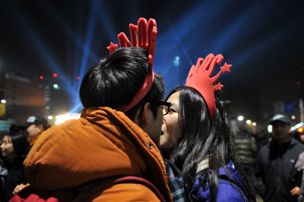 This cute couple kissed in their festive hats in Seoul, South Korea.