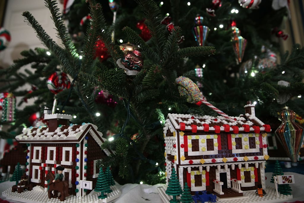 Fifty-six Lego gingerbread houses are nestled in tree branches throughout the State Dining Room.