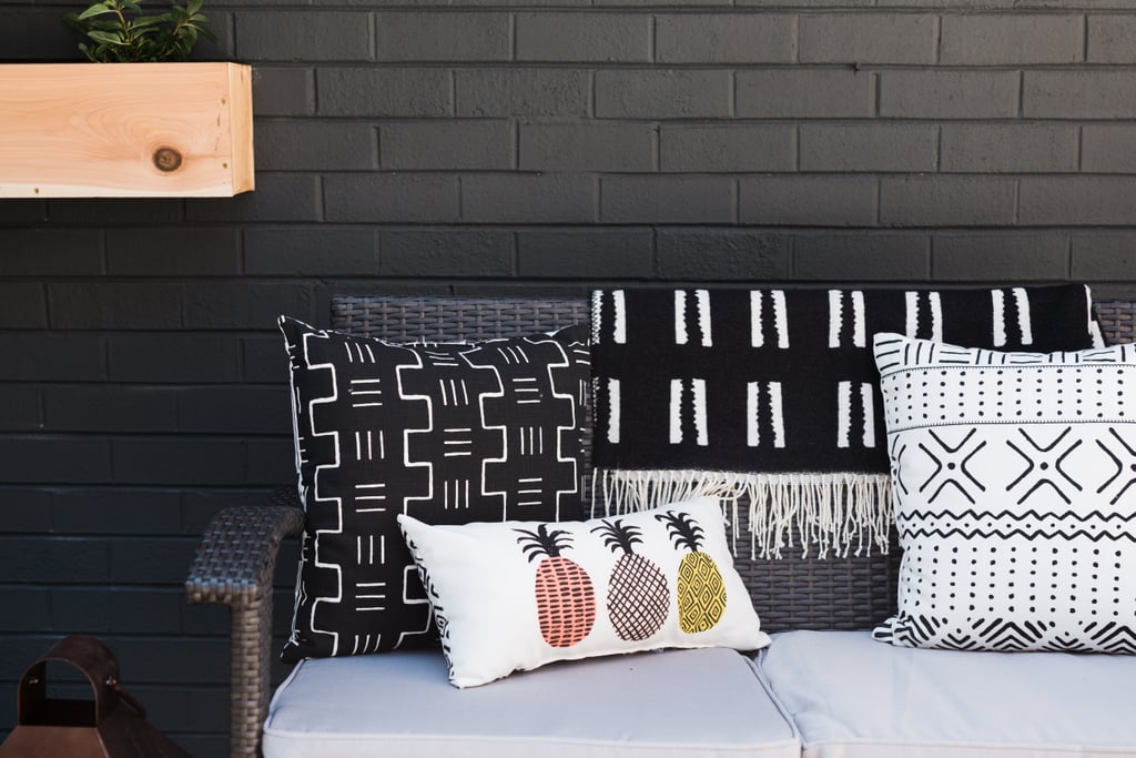 Cozy seating spots, like a 4-piece wicker conversation patio set ($646) are artfully arranged on the deck to accommodate everything from a peaceful moment of relaxation to a lively catch-up session. Thoughtful accents, like throw pillows and
oak resin planters ($15) full of lush flowers, warm up the space and make it the perfect place to entertain.