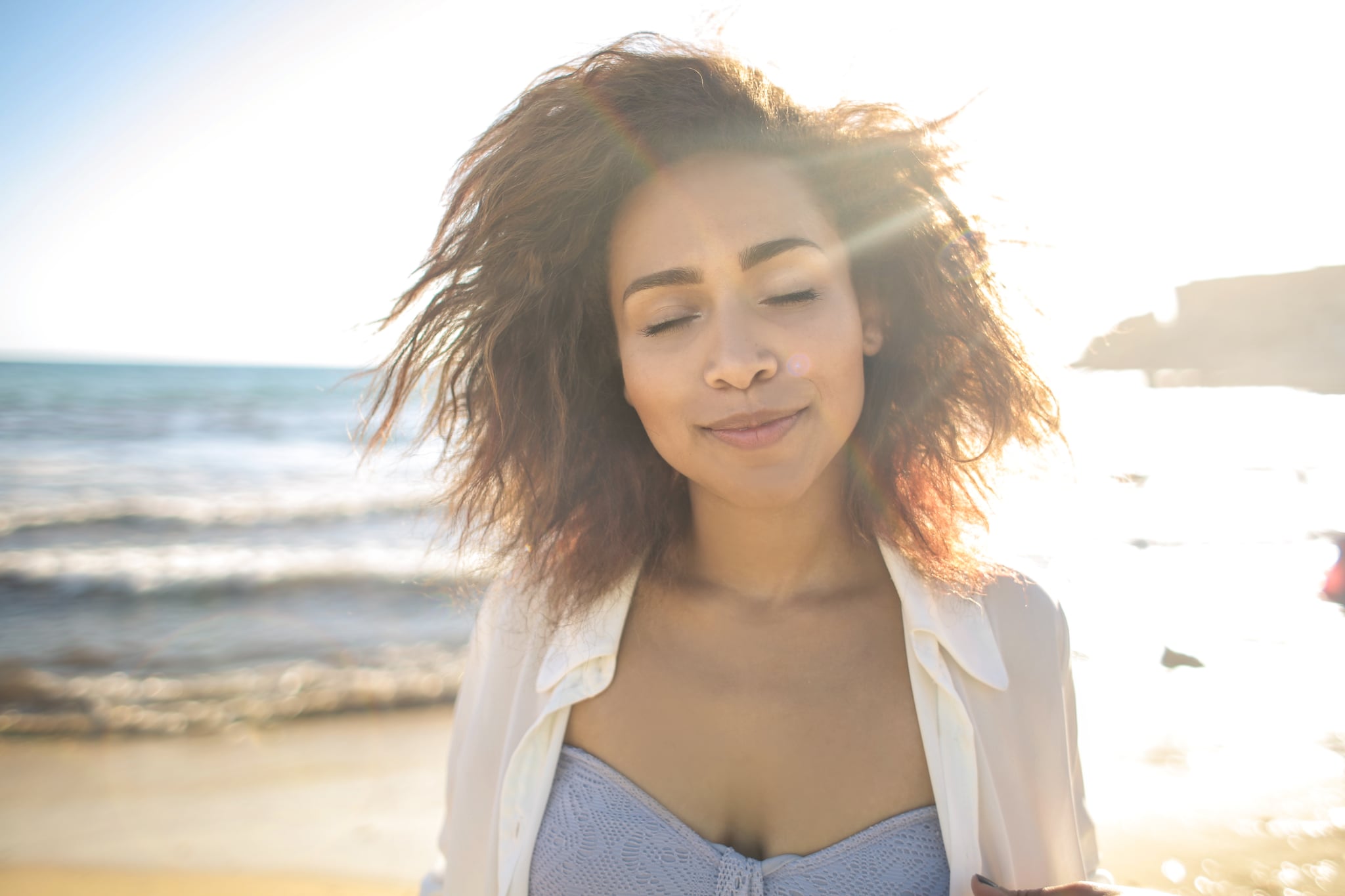 Girl standing at the beach, enjoying her time