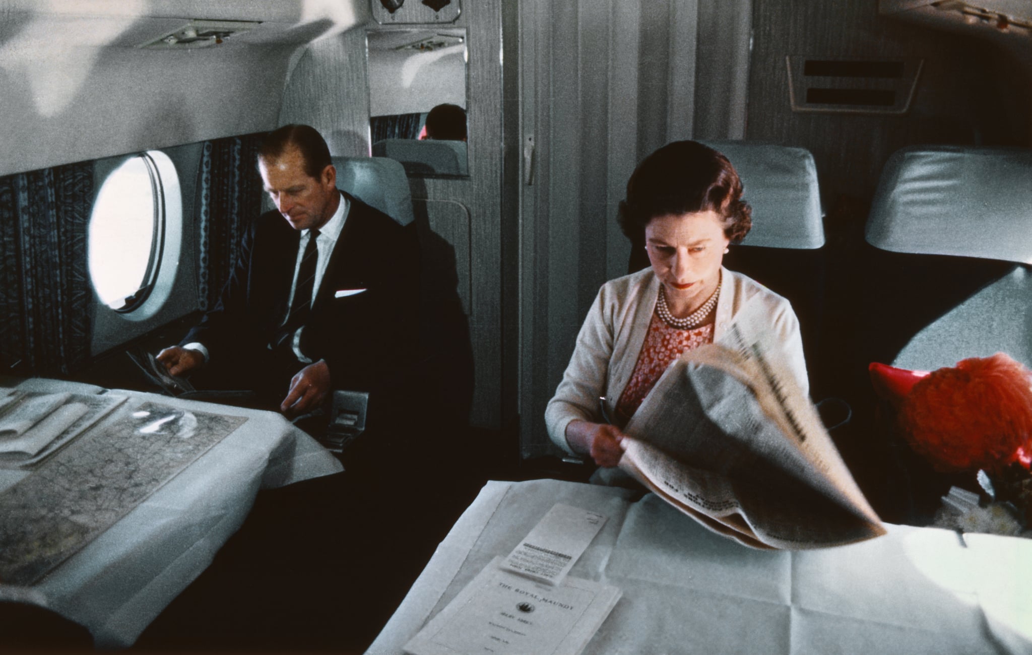 Queen Elizabeth II reading papers on a plane in 1969