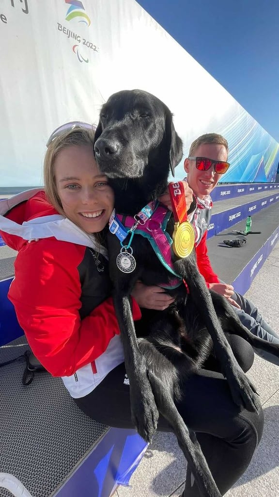 Carina Edlinger Gives Her Guide Dog a Medal on the Podium