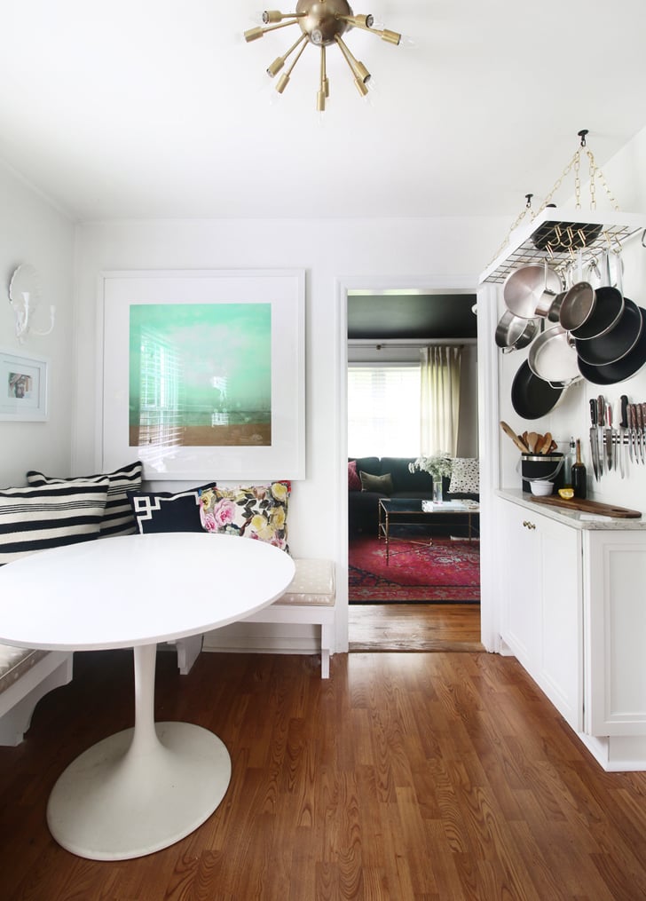 On the opposite side, a hanging rack for pots and pans frees up precious cabinet space.