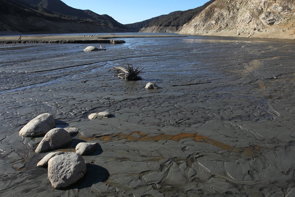 What's left of the San Gabriel River passes over muddy ground.