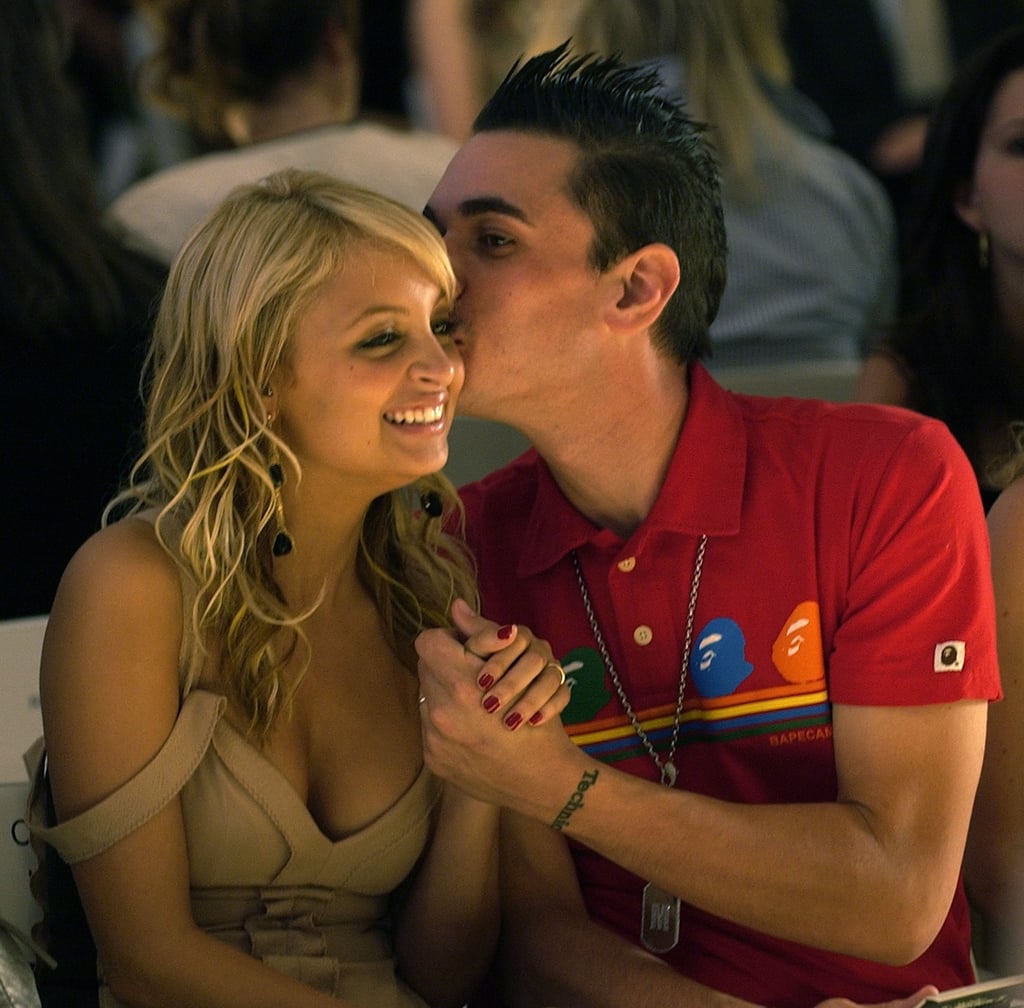 Nicole was given a sweet smooch by her then-boyfriend, the late DJ AM, as they sat front row for the Monique Lhuillier runway show in September 2004.