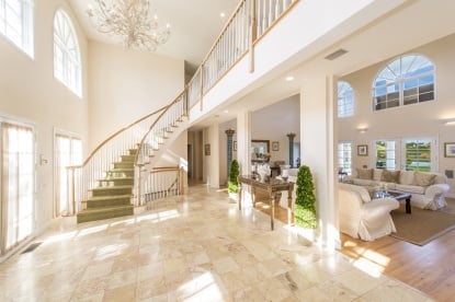 A grand staircase winds its way into the bright foyer — perfect for the RHONY star who is known for making a big entrance!