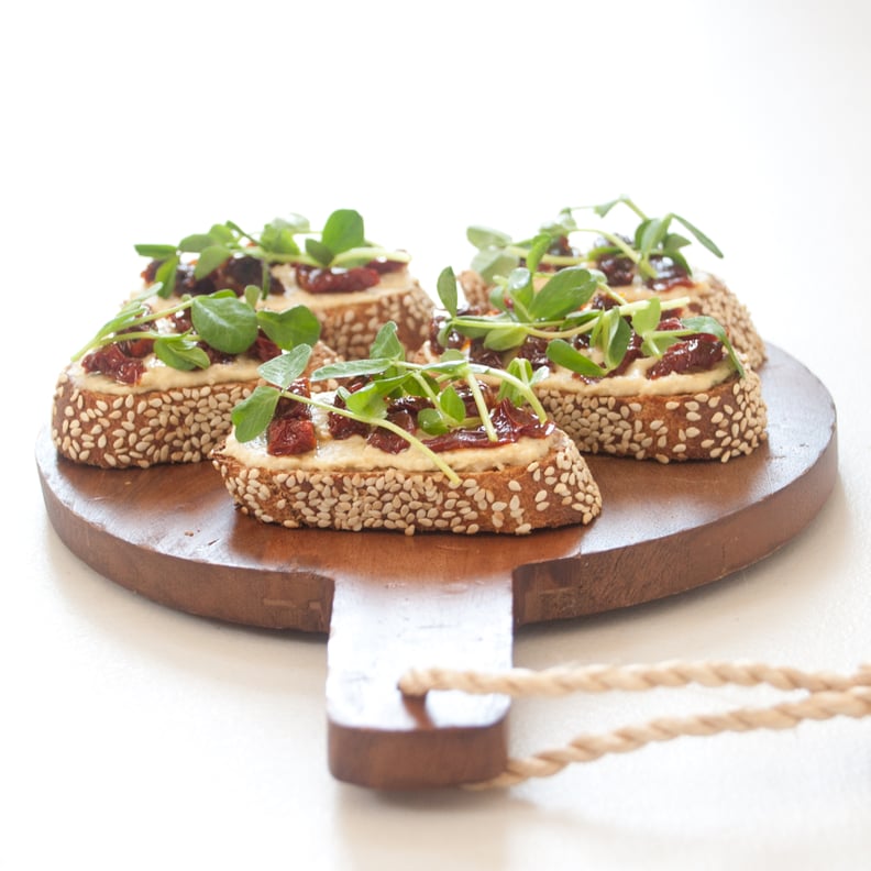 Hummus, Sun-Dried Tomato, and Pea Shoot Crostini