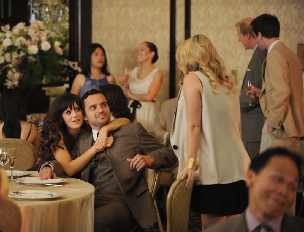 As Nick's wedding date, Jess gets playfully defensive, giving him a squeeze in front of his ex-girlfriend.