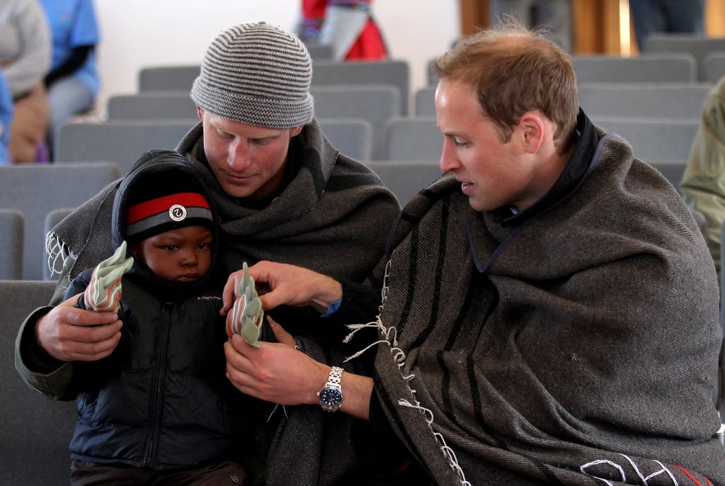 The princes helped a little boy put gloves on during their visit to Lesotho in June 2010. The princes helped a little boy put gloves on during their visit to Lesotho in June 2010.