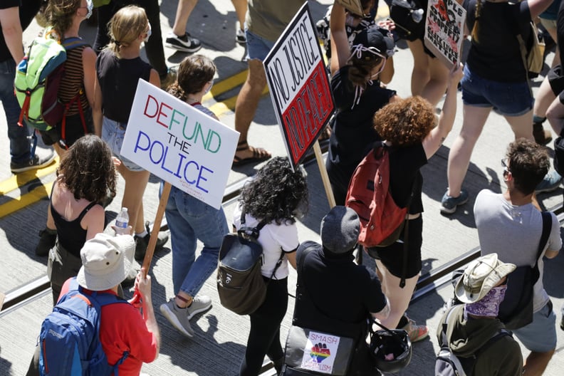 People carry signs during a