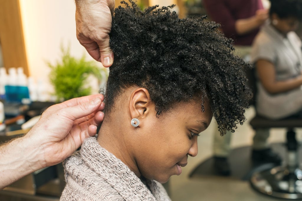 Continue to twist and pin the hair all around the head. Don't worry about parting hair perfectly; just grab and go. All the twists should end near one central point at the crown of the head. In order to keep the twists smooth and flyaways scarce, use a pomade on your fingers as you style.