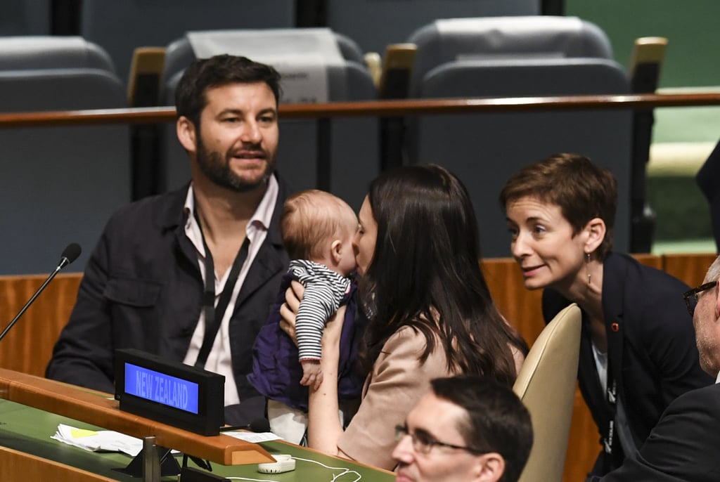 Meet the tiniest diplomat joining the United Nations. On Sept. 24, New Zealand Prime Minister Jacinda Ardern brought her newborn daughter, Neve Te Aroha Ardern Gayford, to the Nelson Mandela Peace Summit ahead of the General Assembly in New York City. In doing so, Ardern made history as the first female world leader to bring a baby to the important meeting. 
Though she made history, Ardern said her decision to bring Neve into the historic Assembly Hall was merely a "practical decision." She told The New Zealand Herald, "Neve is actually nearby me most of the time in New Zealand, she's just not always caught. But here, when she's awake, we try and keep her with me. So that was the occasion."
The prime minister also had help. Her partner, broadcaster Clarke Gayford, was seated beside her. Following the meeting, Gayford shared a picture of an "official" ID the staff at the UN created for Neve, which refers to her as New Zealand's "First Baby." Gayford added, "I wish I could have captured the startled look on a Japanese delegation inside UN yesterday who walked into a meeting room in the middle of a nappy change."