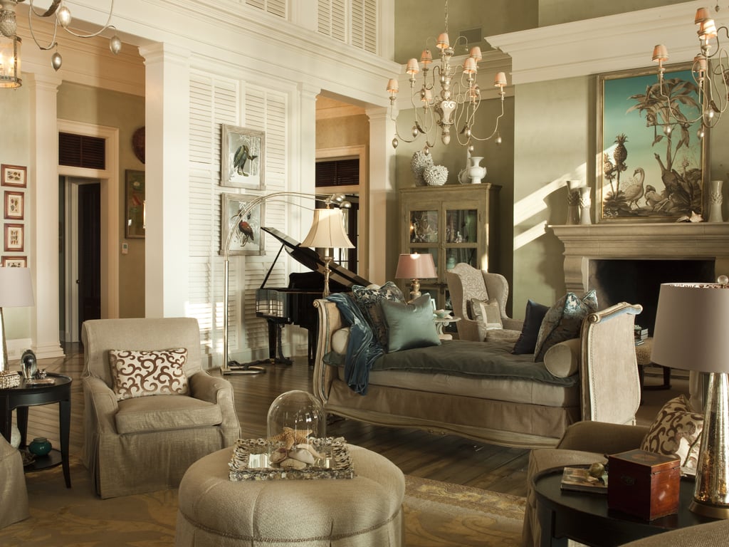 The dramatic living room features soaring ceilings and charming | Paula ...