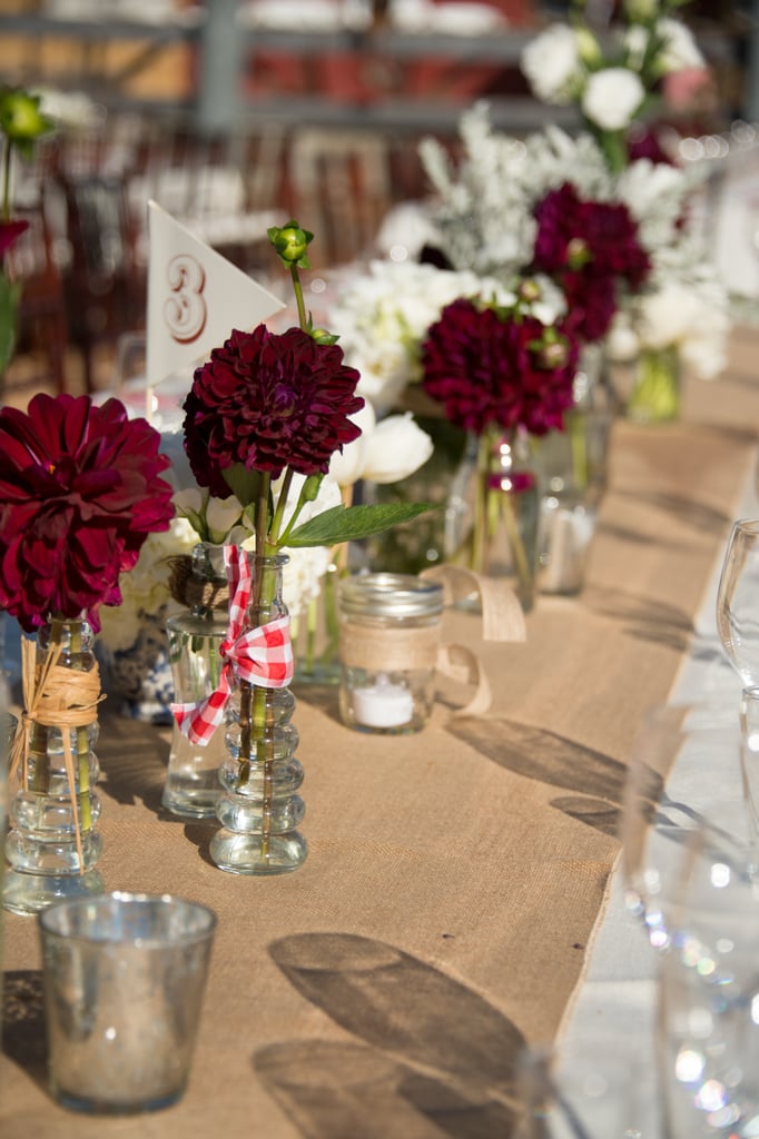 Place single stemmed flowers on a burlap table runner.