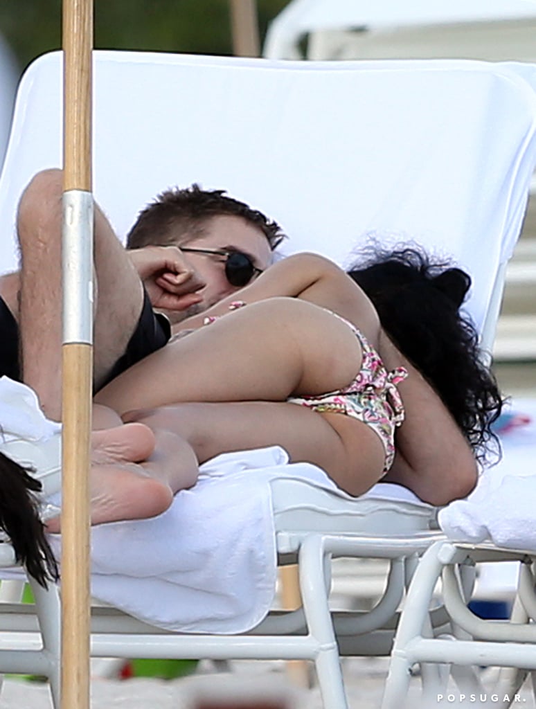 Robert Pattinson and FKA Twigs got hot and heavy in their beach chairs during a trip to Miami in December 2014.