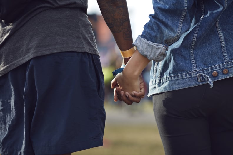 Close-up of couple holding hands at festival