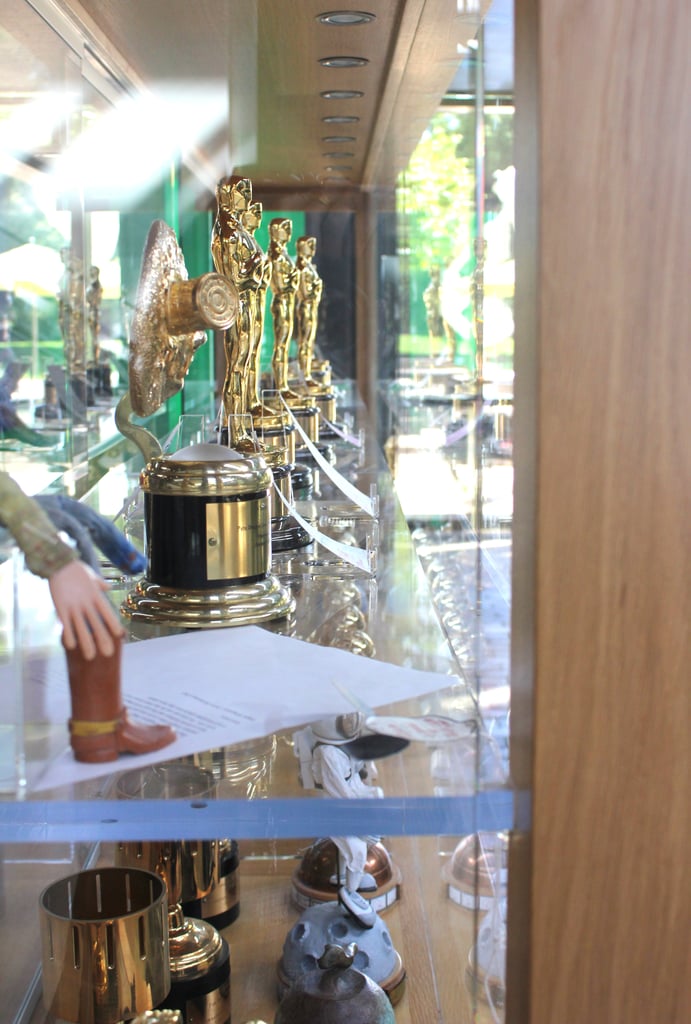 There's a glass cabinet filled with Oscars, Golden Globes, and more awards.