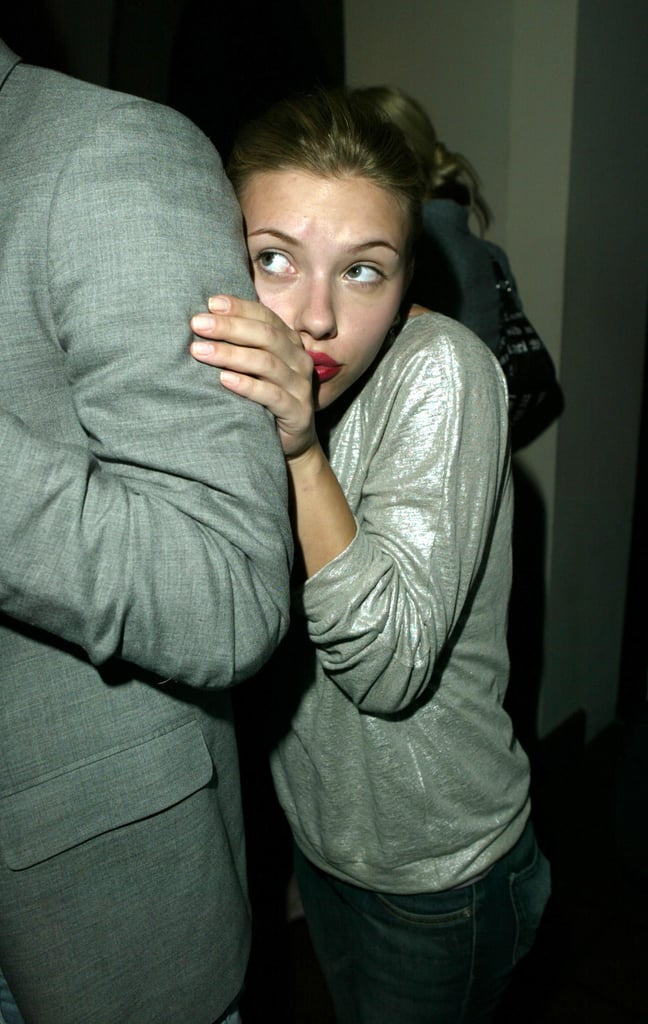 Scarlett playfully hid behind a friend at a party in 2004.