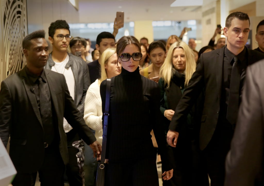 She accessorized with oversize sunglasses and a leather purse.