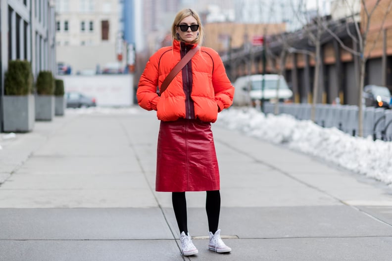 With an Orange Puffer Jacket, a Red Leather Skirt, and Black Tights