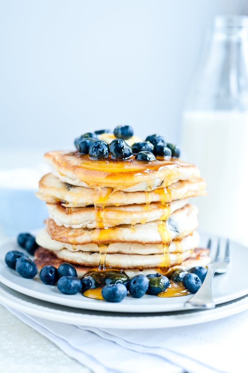 Blueberry pancakes with fresh blueberries and golden syrup.