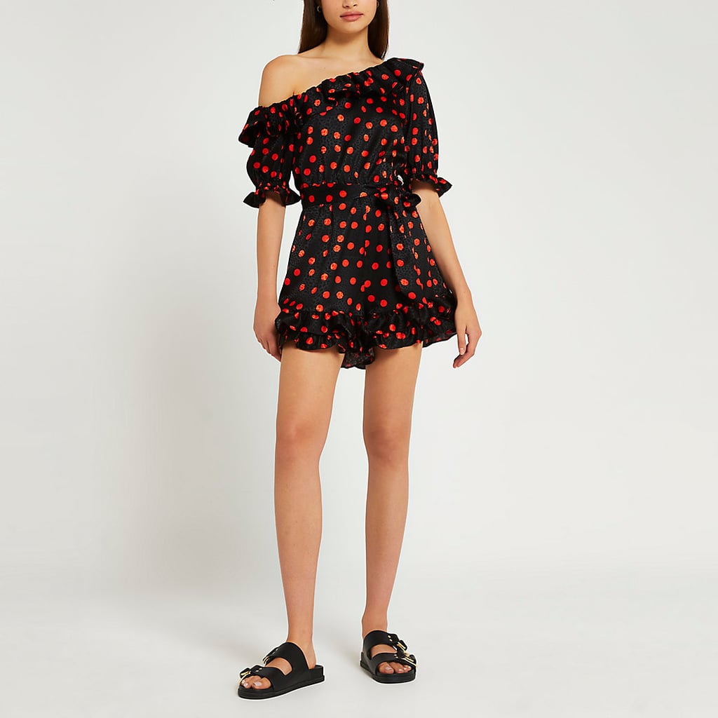 A One-Shoulder Romper: River Island Black Spot Print Asymmetric Playsuit