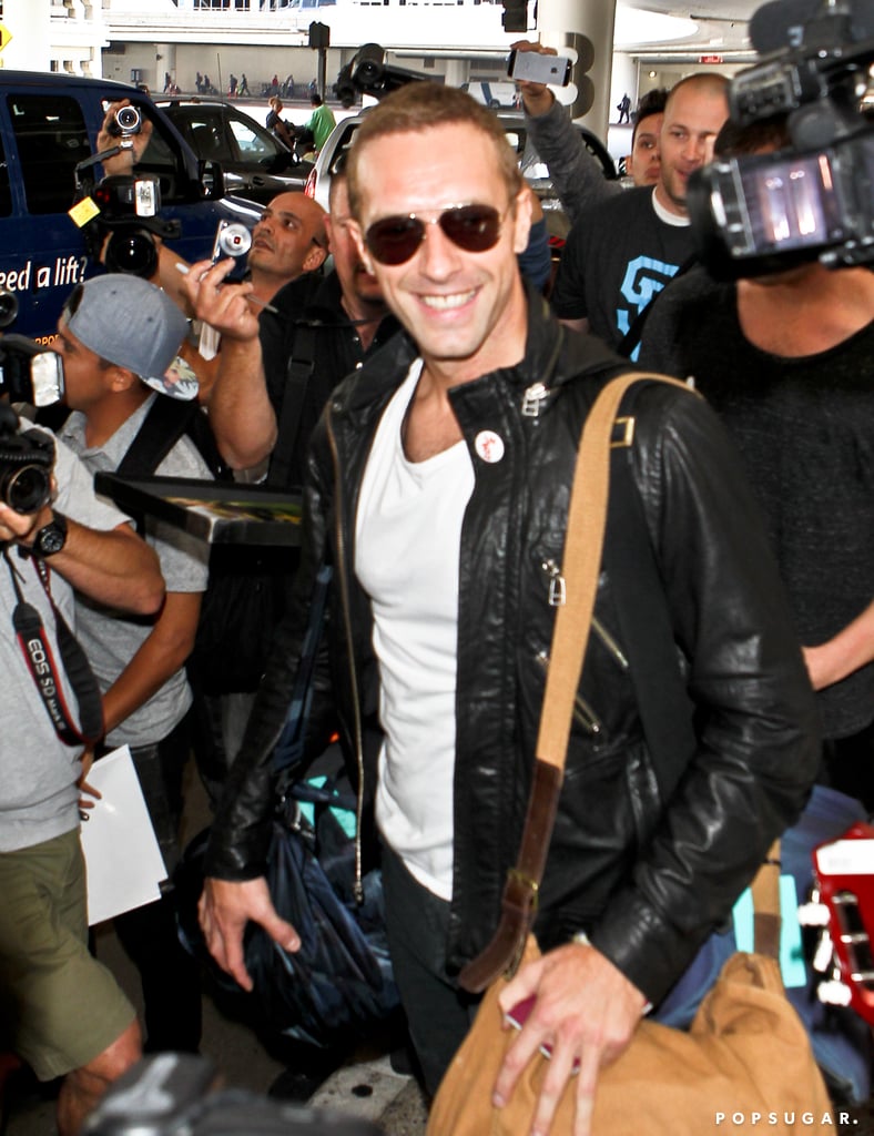 Chris Martin smiled while walking through LAX on Thursday.