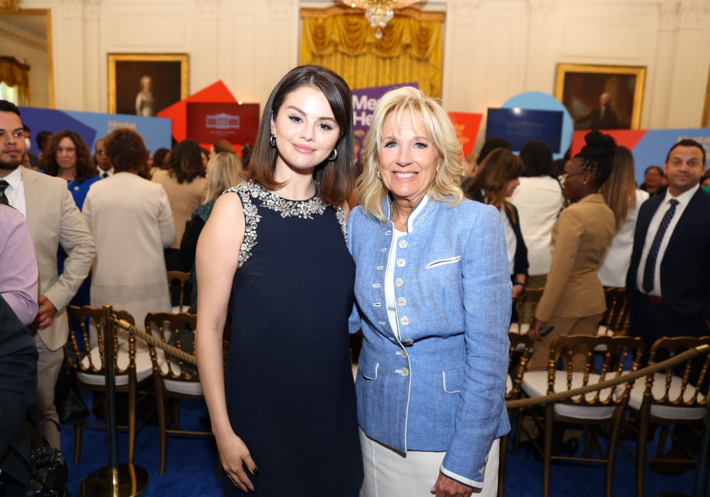 Selena Gomez made her White House debut in style when she attended MTV Entertainment's new Mental Health Youth Action Forum on Wednesday, May 18, in Washington DC. Accompanied by FLOTUS Jill Biden, US Surgeon General Dr. Vivek Murthy, and Ambassador Susan E. Rice, Gomez hosted an open conversation about youth mental health and her personal self-care journey. For the special occasion, the "Only Murders in the Building" star opted to wear a sleeveless Oscar de la Renta Shift Dress ($3,290) adorned with crystal embellishments along the neckline. She styled the look with Stuart Weitzman 100 Strap Pumps in white and silver hoop earrings. 
The LBD casts a simple yet refined silhouette, flaring out slightly around her mid-thigh to convey a sense of easy elegance. In keeping with the effortlessly chic theme, Gomez styled her hair into a sleek lob and rocked a rounded black manicure. In contrast, Dr. Biden arrived in a polished white pencil skirt paired with a pale-blue button-front blazer.
During the forum, Gomez, who is a strong proponent of therapy and taking social media breaks for her mental health, explained that there's an untapped power in discussing mental health as a community. "Mental health is very personal for me, and I hope that by using my platform to share my own story — and by working with incredible people like all of you, of course you, Dr. Murthy — I can help others feel less alone and find the help that they need, which is, honestly, all I want," she said. 
Gomez, who has openly commented on her personal experiences with depression, anxiety, and bipolar disorder in the past, also recently launched Wondermind, a platform intended to "destigmatize and democratize mental health." 
See Gomez's refined ensemble at the White House Mental Health Youth Action Forum ahead. 

    Related:

            
            
                                    
                            

            Selena Gomez Hits the Red Carpet in an Affordable Miniskirt Set