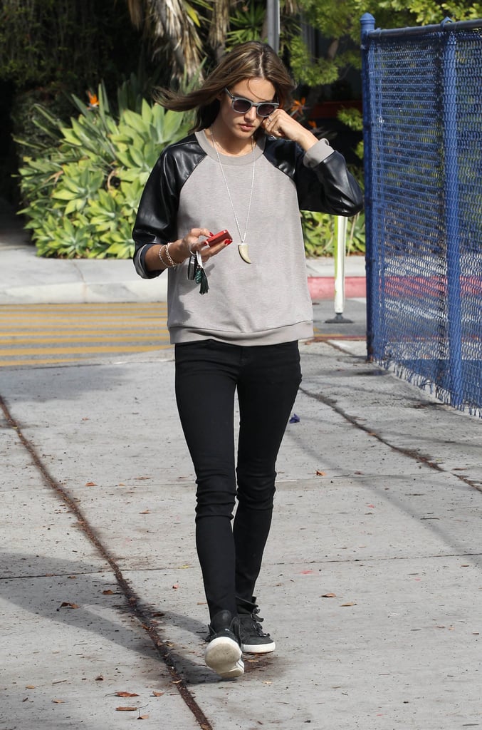 There was a sporty vibe in this Fall outfit she put together in LA. Along with sneakers, she picked a crewneck sweatshirt with black leather sleeves.