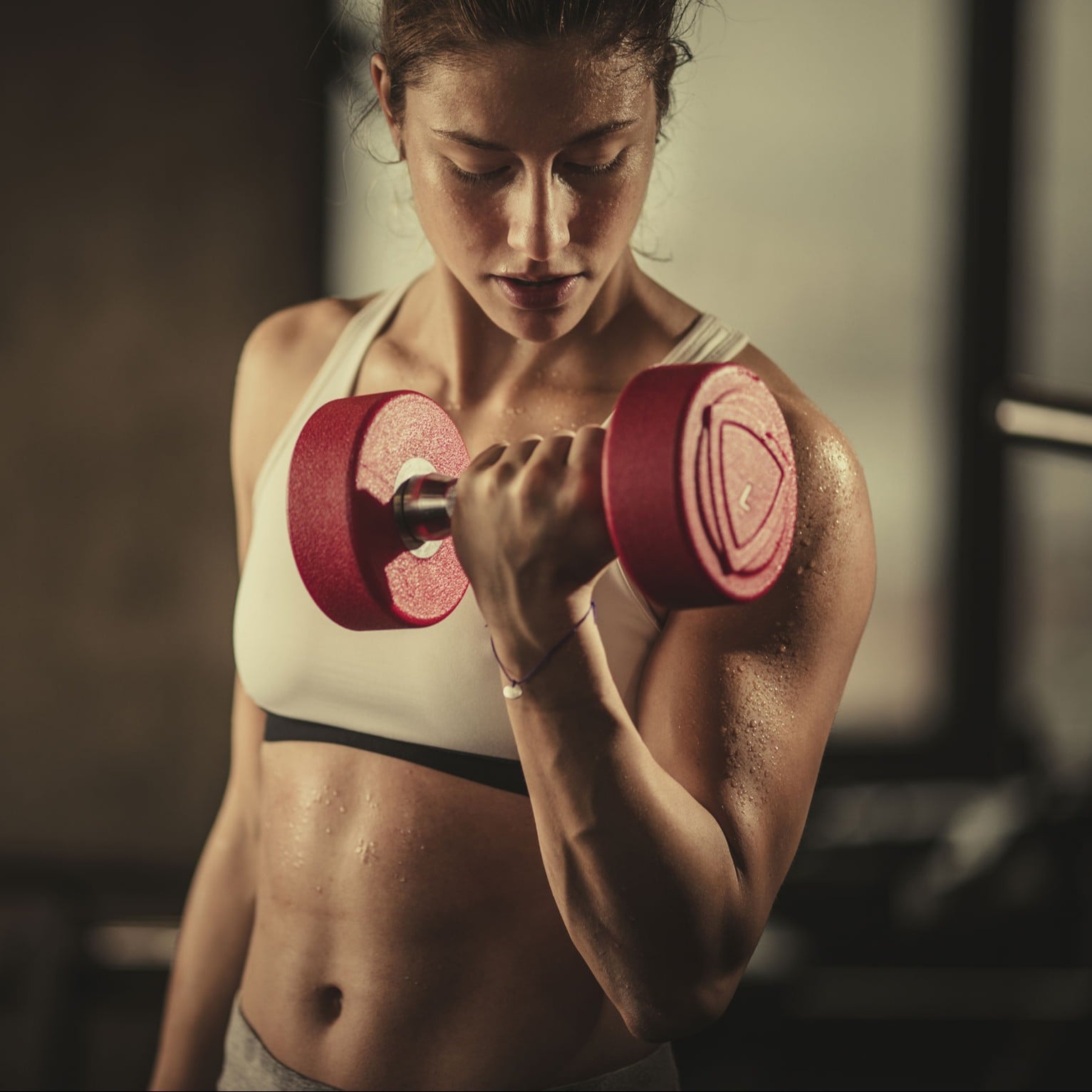 Premium Photo  A tall athletic woman performs an exercise with dumbbells  with weights in the gym Exercises with dumbbells fitness muscular body