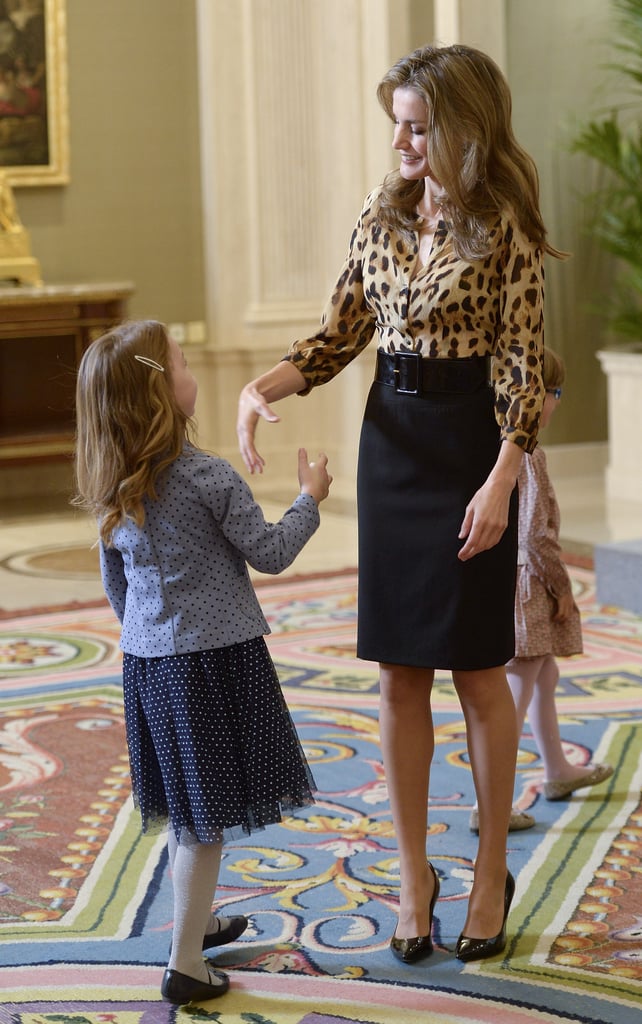 She shook hands with a little girl while visiting with people at Zarzuela Palace in October 2013.