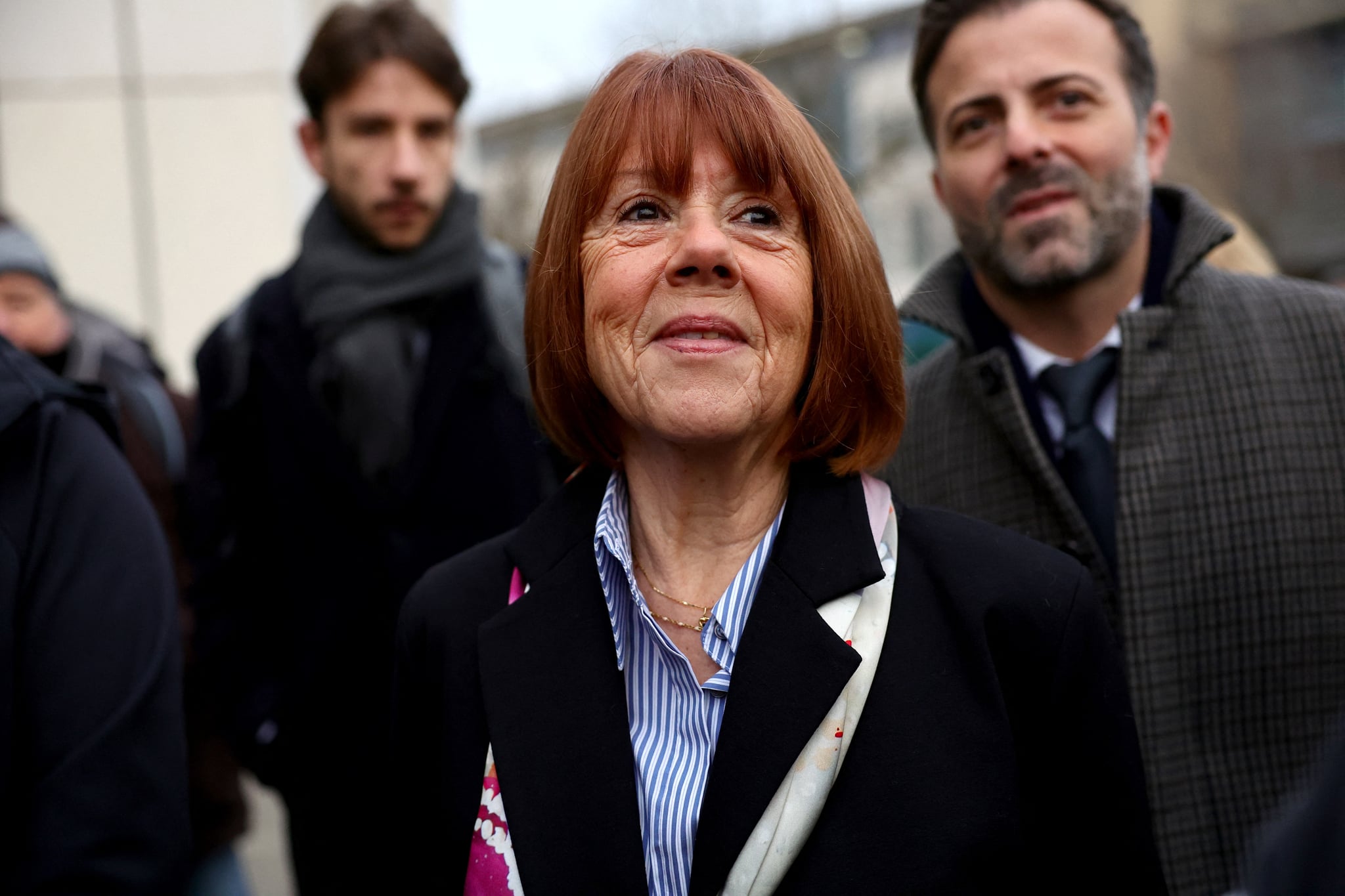Gisele Pelicot (C) arrives with her lawyer Antoine Camus (R) at the courthouse in Avignon on December 19, 2024, as the verdict is expected in the trial of her ex-husband, with 50 others, accused of drugging her and orchestrating multiple rapes over nearly a decade.