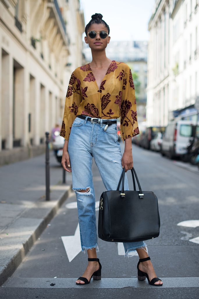 Smarten up a ripped pair with a tucked in sheer blouse, oversize bag, and heels.