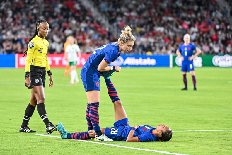 ST. LOUIS, MO - APRIL 11: U.S. Women's National Team midfielder Kristie Mewis (22) helps U.S. Women's National Team forward Alyssa Thompson (28) work out a cramp during an international friendly game between the Republic of Ireland Woman's National Team a