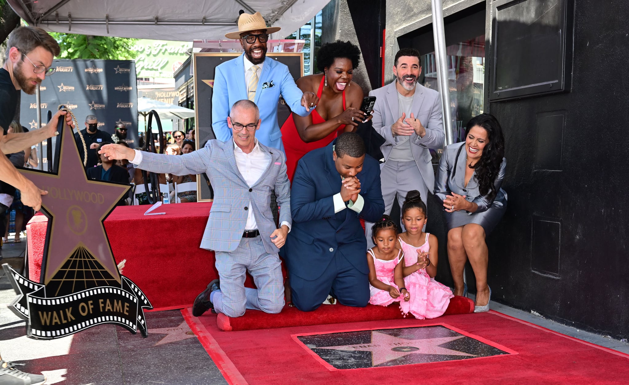 Comedian and actor Kenan Thompson reacts beside his two daughters as his Hollywood Walk of Fame Star is unveiled on August 11, 2022 in Hollywood.Attending the ceremony behind Thompson are (L to R) JB Smoove, Josh Server, and Leslie Jones. - Thompson's distinction will make him the 2,728th star in the Hollywood Walk of Fames television category. (Photo by Frederic J. BROWN / AFP) (Photo by FREDERIC J. BROWN/AFP via Getty Images)