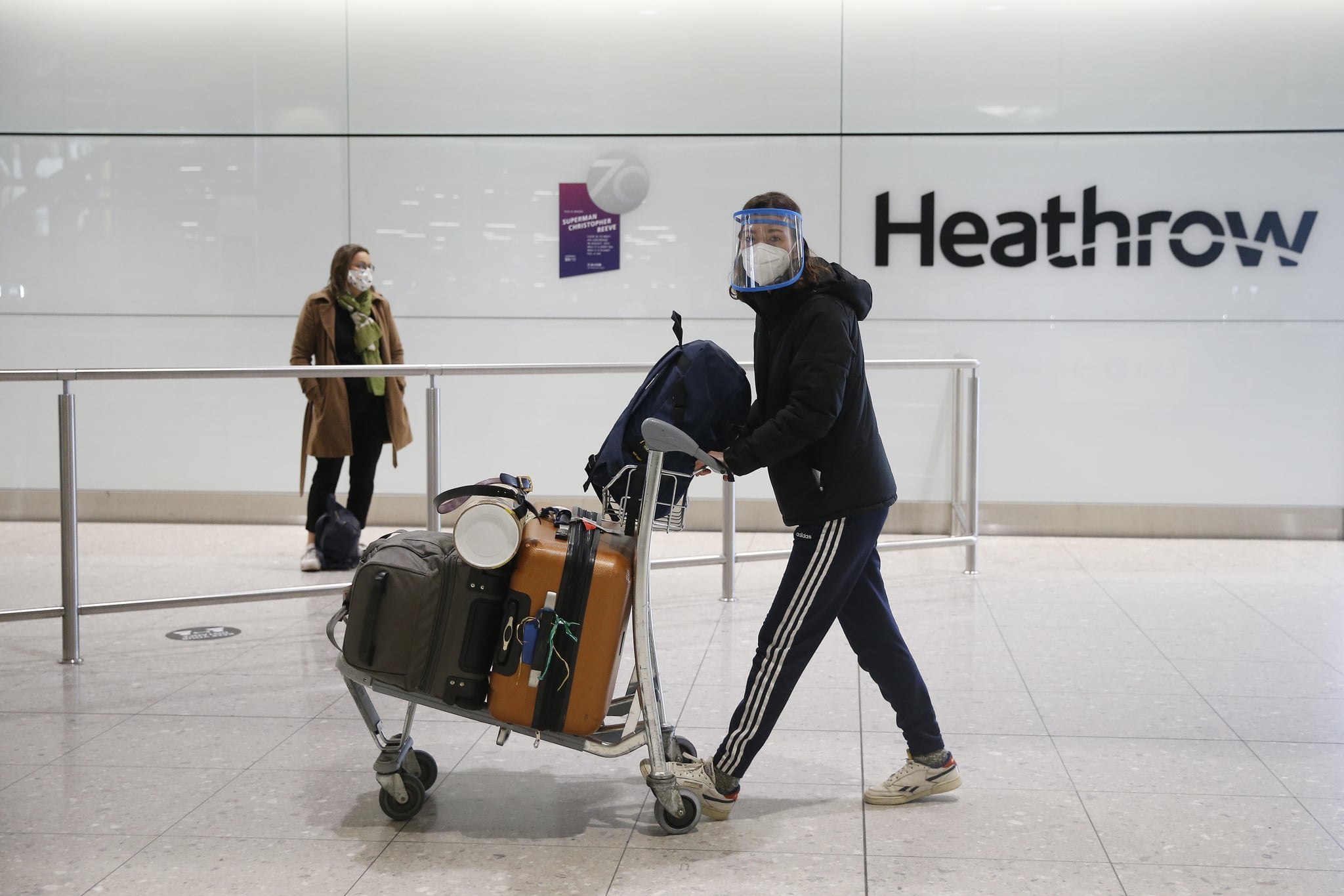 LONDON, ENGLAND - JANUARY 30: Travelers arrive at Heathrow Terminal 2 on January 30, 2021 in London, England. The UK government has added flights from the UAE to the 