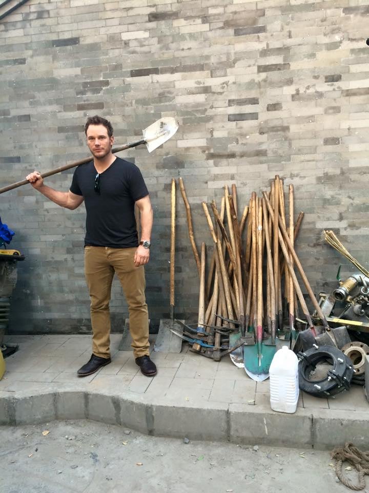 While in China, Chris posed with "some shovels and sh*t."