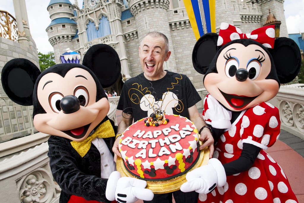 Alan Cumming was presented with a huge cake when he visited Disney World on Monday.