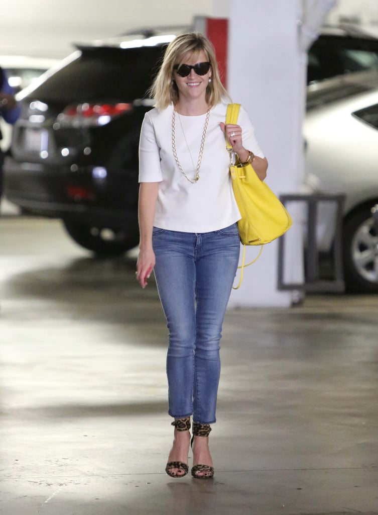 Reese's classic canvas — a white tee and skinny jeans — let her leopard ankle-strap sandals really shine.