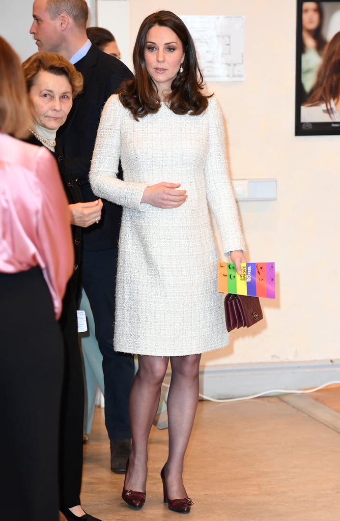 Once inside, Kate took off her coat to reveal a cream-colored Alexander McQueen tweed dress.