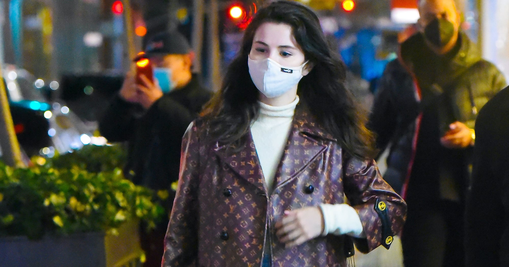 Selena Gomez Wearing Logo-Covered Louis Vuitton Coat in NYC