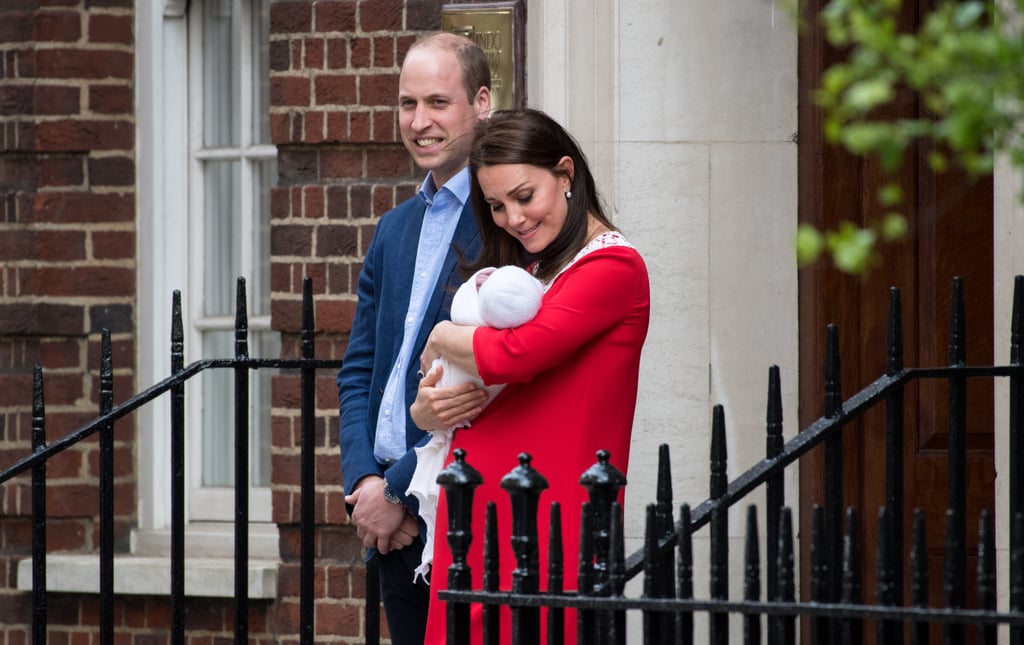 As Prince William looks into the crowd of people at the hospital, Kate gets lost in little Louis.