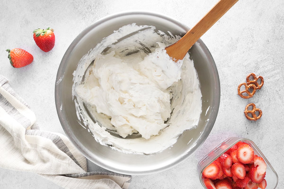 Whipped topping and cream cheese in a bowl